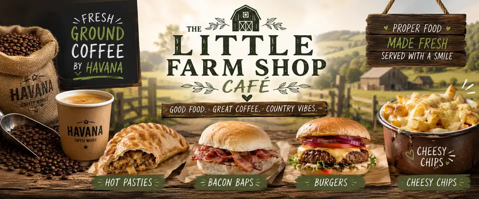 The little farm shop café’s rustic wooden sign with a barn illustration and green lettering.