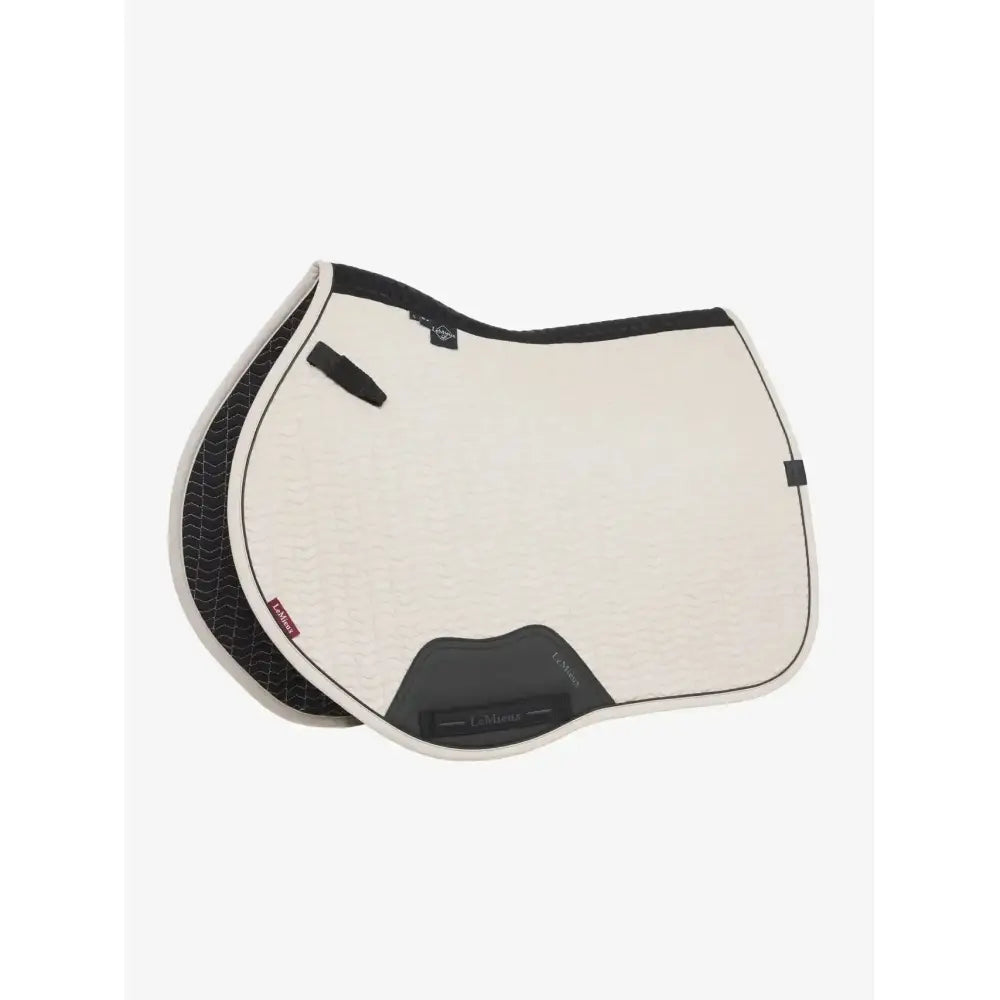 Cream-colored finesse eurojump faux leather saddle pad with black trim and textured backing by equine eurojump square stone