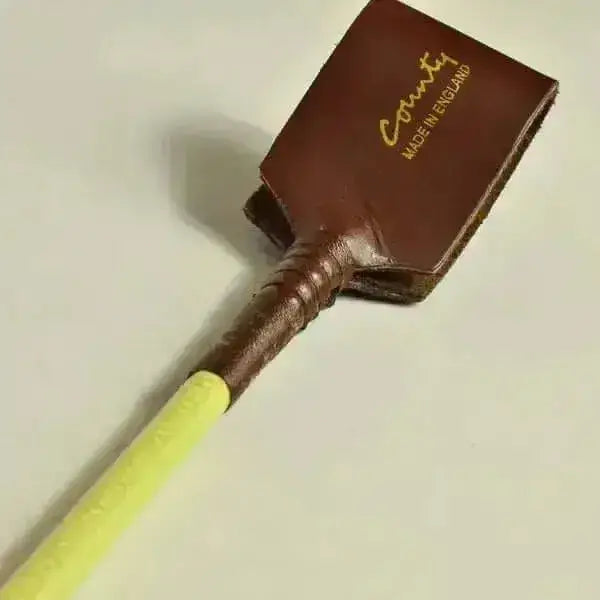 Brown leather flax stem riding crop with yellow handle and gold county made in england lettering super stylish high quality riding whip