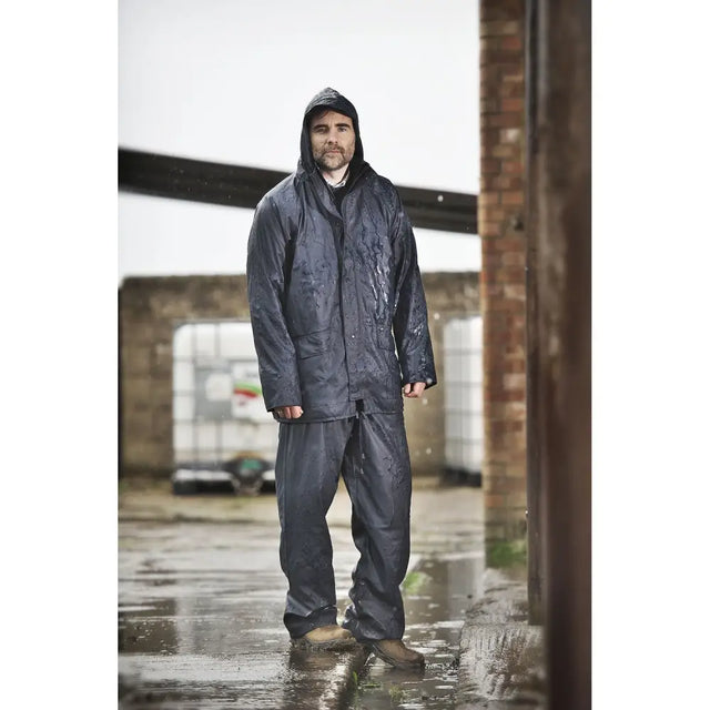 Dark gray waterproof rain suit with hood and button closure paired with fort airflex trouser navy breathable over-trousers