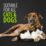 Brindle dog and black and white cat resting next to furminator bathing brush that loosens pet hair and promotes shiny coats
