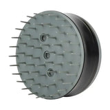Gray plastic furminator bathing brush with short bristles and three circular openings to loosen pet hair and promote shiny coats