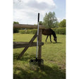 Black and silver fynalite plastic stable fork long handle leaning against wooden fence for pellet bedding use