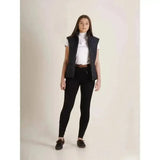 Black quilted vest with front zipper and structured shoulders, paired with silicone seat breeches and elasticated ankle cuffs