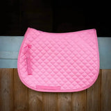 A vibrant pink gallop high density quilted saddle pad with diamond pattern and matching straps for horses