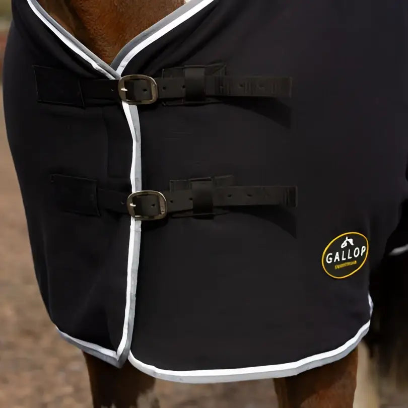 Black gallop jersey cooler rug with white trim and silver buckles perfect as a jersey cooler rug or cooler rug green alternative