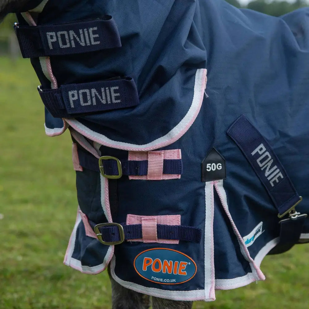 Navy blue gallop ponie duraproof 50g turnout combo rug with pink white trim adjustable straps and brass buckles