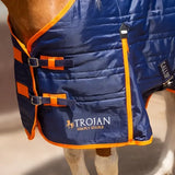 Blue quilted gallop trojan 100g stable rug with orange trim black buckles and optional neck cover logo visible