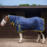 Navy blue quilted gallop trojan 200g stable rug combo navy with yellow trim and brand logos for horse use