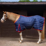 Navy blue quilted gallop trojan 200g stable rug with red trim and brand logos ideal for stable use