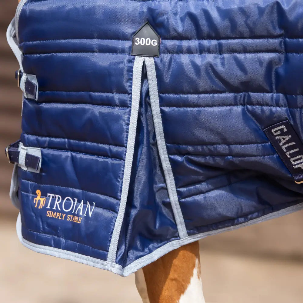 Deep navy blue quilted gallop trojan 300g stable rug with light gray trim and adjustable straps for heavy weight use