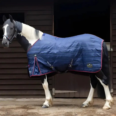 Blue quilted gallop trojan 50g stable rug lightweight with maroon trim and logo patch, no neck cover visible