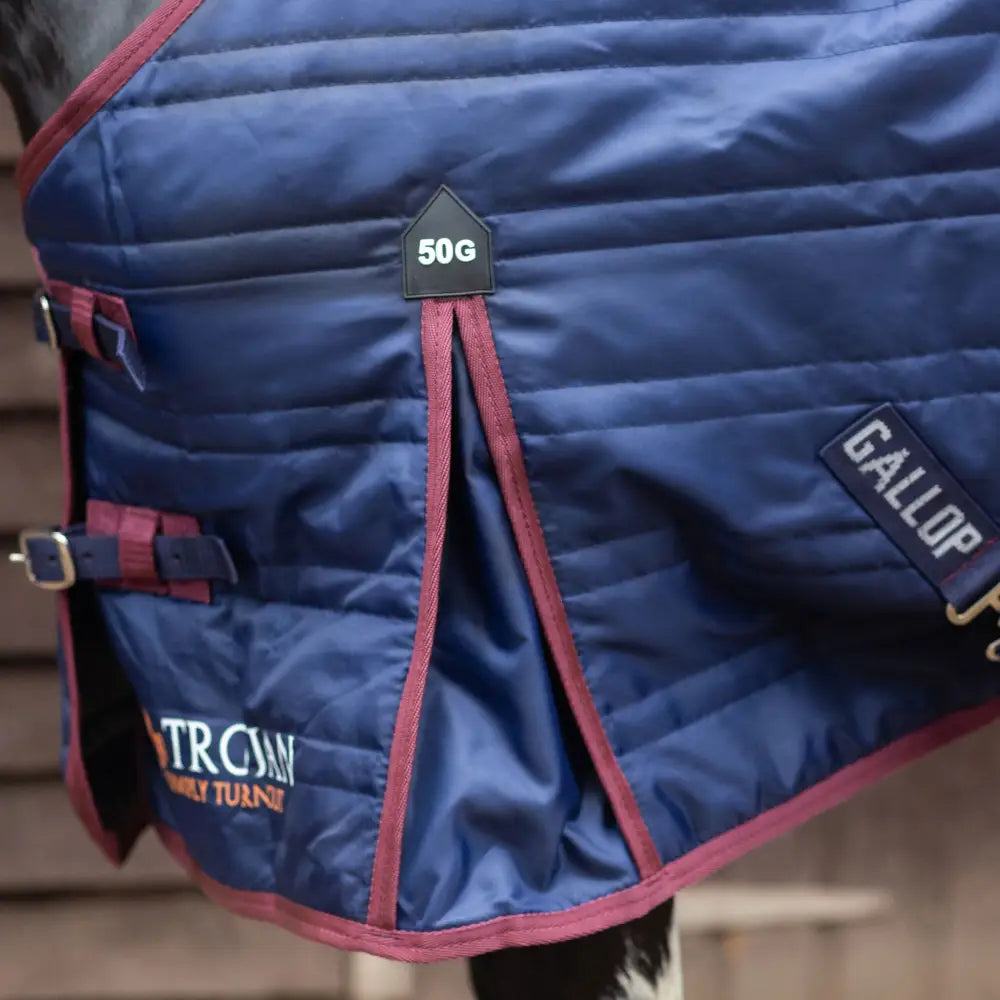 Navy blue quilted gallop trojan 50g stable rug lightweight with maroon trim and neck cover buckle detail