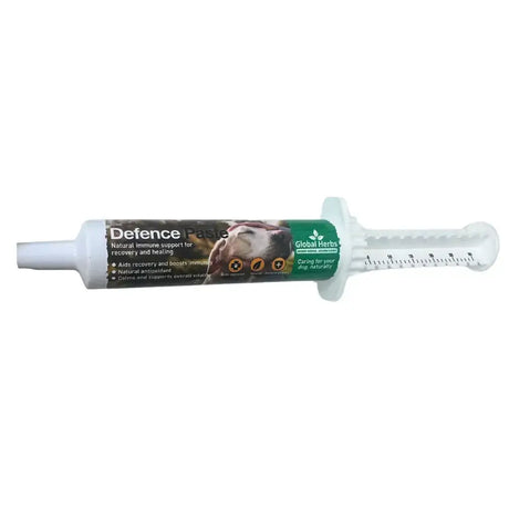 White plastic syringe tube of global herbs herbs canine defence paste with green brown label for natural immune support