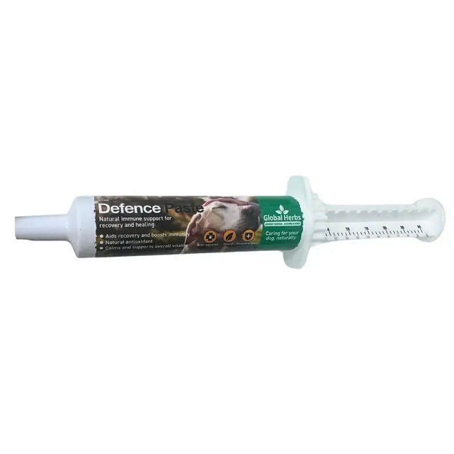 White plastic syringe tube of global herbs herbs canine defence paste with green brown label for natural immune support