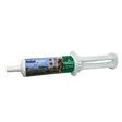 White plastic syringe tube of global herbs canine relief paste with green and blue label featuring a dog image