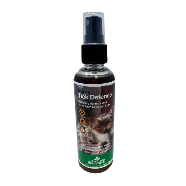 A 100ml transparent spray bottle with black pump labeled home tick defence by global herbs for canine tick defence