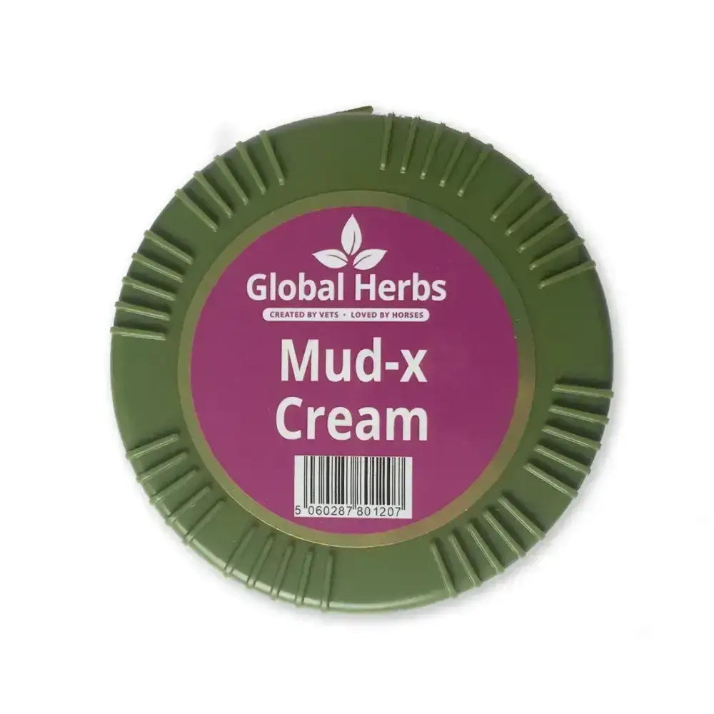 Olive green circular container of global herbs mud-x cream with textured rim and purple label for muddy winter conditions