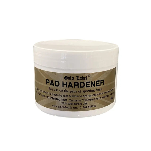 White plastic jar with beige label and black text labeled gold label canine pad hardener for sporting dogs footpads