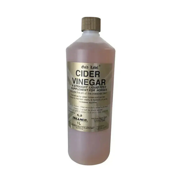 A 1 liter bottle of gold label cider vinegar with translucent pinkish liquid and gold cap for laminitic horses