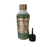 A 236ml bottle of trilanco gold label clipper oil with translucent green liquid and gold ribbed cap for high quality lubrication
