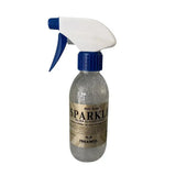 Silver glitter spray in clear bottle with blue white trigger sprayer labeled bold label by trilanco gold label sparkle