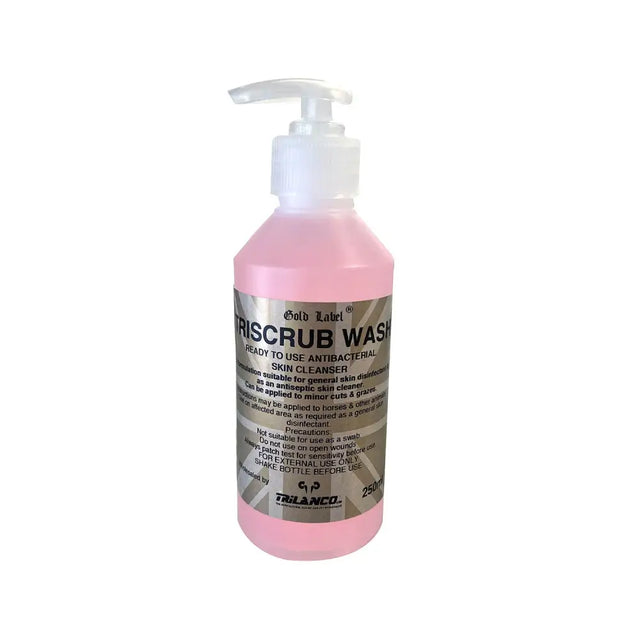 Pink liquid-filled pump bottle of gold label triscrub wash by trilanco for gentle skin cleansing