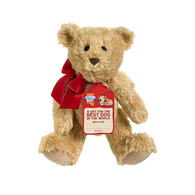 A plush tan teddy bear with a red satin bow and good boy gift tag perfect for dog treats and dog lovers