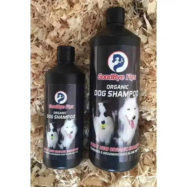 Two black plastic bottles of goodbye flys dog organic dog shampoo with stylized dog logo and dog images on label