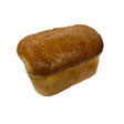 Golden brown granary farmhouse bread loaf ryders bakery with glossy crust and visible seeds perfect round white bread option