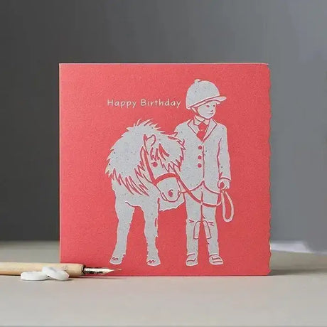 Happy birthday card child with pony coral red textured design with white embossed equestrian illustration and unique die-cut edging