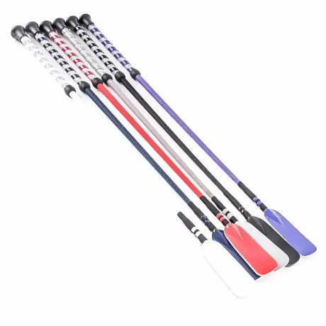 A set of colorful harlequin crystal riding crops with patterned handles and sleek solid-colored shafts for riding fun