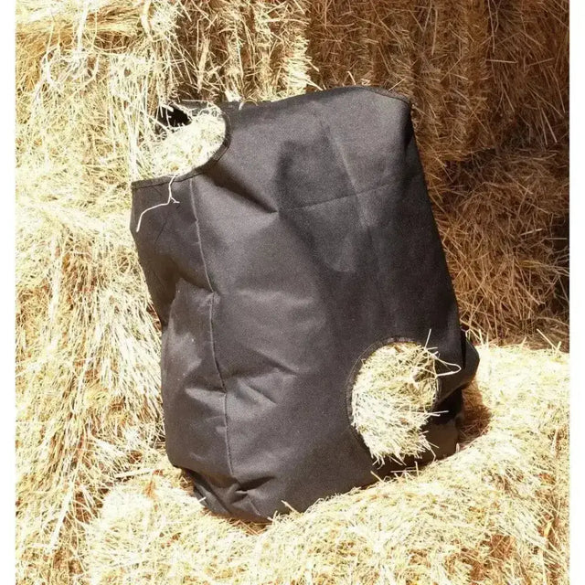 Black canvas harlequin haybag with two circular openings for easy horse feed access