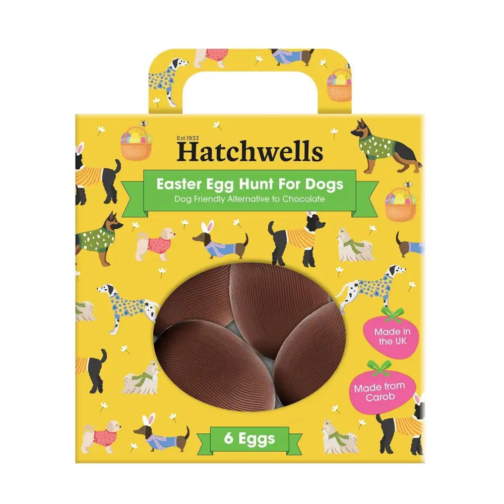 Yellow cardboard hatchwells easter egg hunt box with cartoon dogs and six brown chocolate eggs inside window