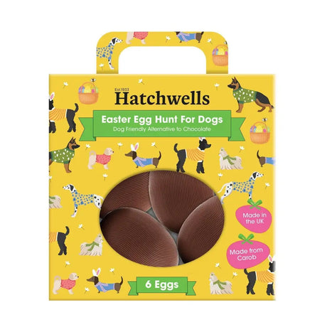 Yellow cardboard hatchwells easter egg hunt box with cartoon dogs and six brown chocolate eggs inside window