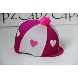 A vibrant pink and white striped pom poms hat silks two colour riding hat cover with heart cutouts and fluffy pom pom