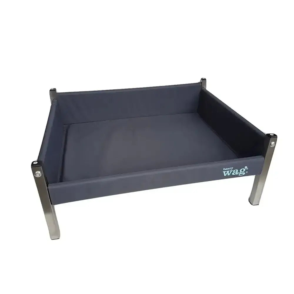 Dark gray canvas henry wag elevated dog bed with stainless steel legs and firm wooden base visible on the side