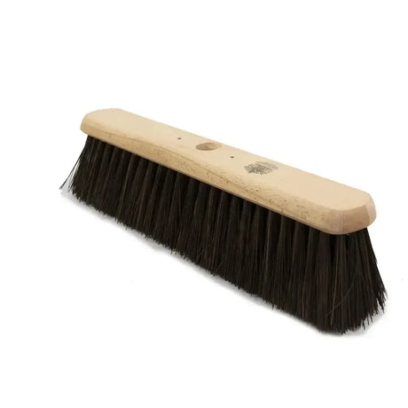 A sturdy hillbrush finest platform broom head with stiff bahia black bristles and a light wood handle