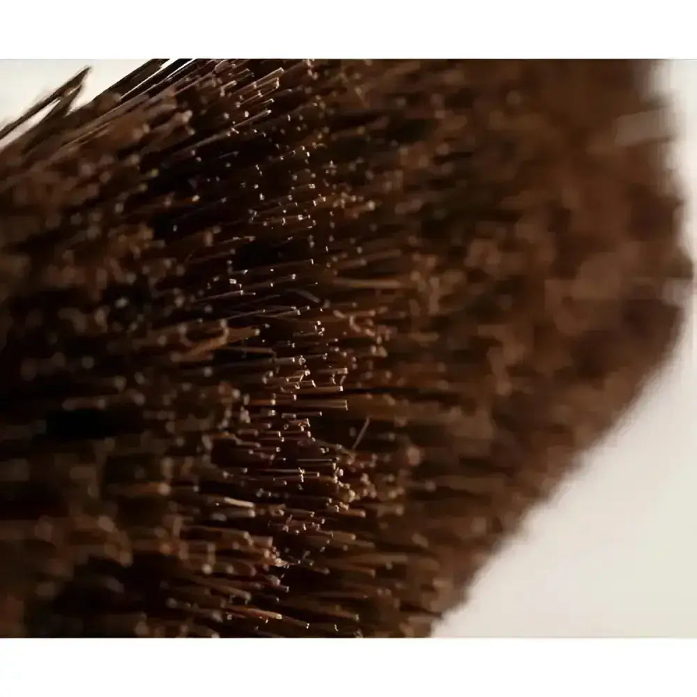 A dense dark brown hillbrush industrial stiff yard broom head with tightly packed fine bristles for tough cleaning