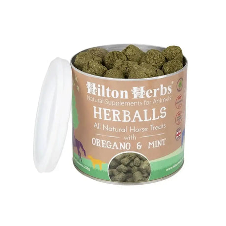 A cylindrical container of hilton herbs herballs horse treats with a tan and green label featuring oregano and mint herbs