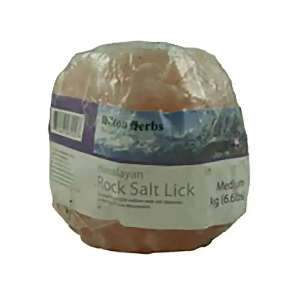 A natural irregular shaped softer pressed himalayan salt lick wrapped in clear plastic labeled bhoo herbs by hilton herbs himalayan