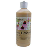 A beige plastic bottle with a white cap labeled hilton herbs mud defender mud defender lotion with purple coneflowers