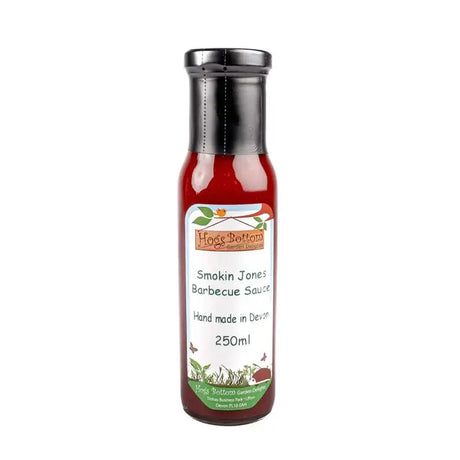 A glass bottle of hogs bottom smokin jones bbq sauce 250ml with a silver cap and label featuring green foliage and butterflies