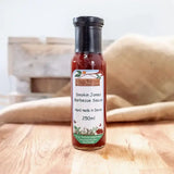 A glass bottle of hogs bottom smokin jones bbq sauce 250ml with rich red sauce and green accented label