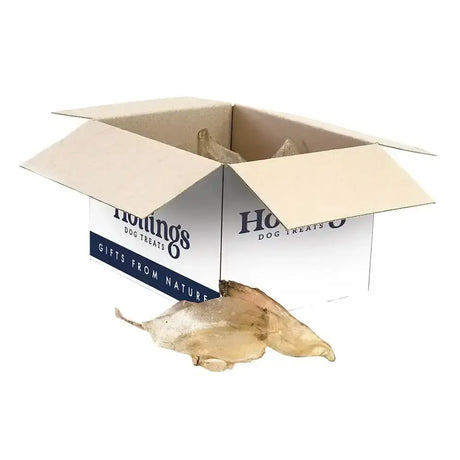 Open cardboard box of hollings cow ears dog treats with white and navy label for healthy longer lasting chew natural cows ears