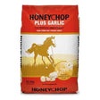 Red and white bag of honeychop plus garlic horse feed with golden running horse silhouette for equestrian use