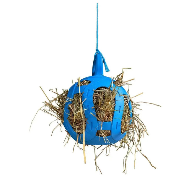 Blue plastic horsemen’s pride jolly hay ball filled with straw for feeding horses and pets