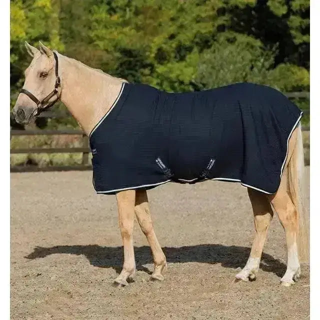 Navy blue horseware rambo techni waffle cooler horse rug with white trim and breathable textured fabric design