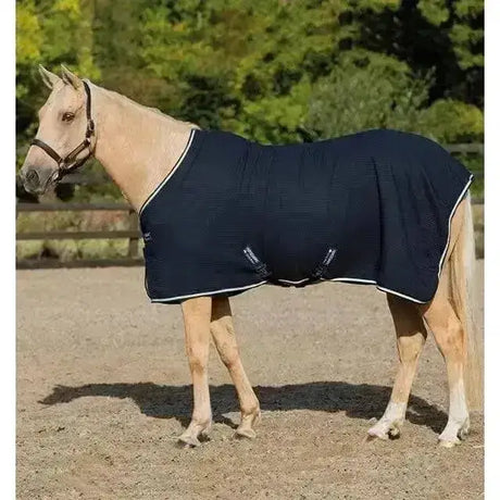 Navy blue horseware rambo techni waffle cooler horse rug with white trim and breathable textured fabric design