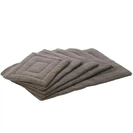 Stack of gray plush quilted paws berber crate mats made of soft fleece dog mat material for cozy pets